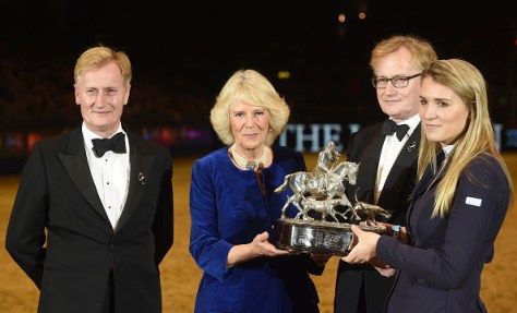 LONDON, ENGLAND - DECEMBER 17: Camilla, Duchess of Cornwall presents the Raymond Brooks-Ward Memorial Trophy to winner Jessica Mendoza during The London International Horse Show at Olympia Exhibition Centre on December 17, 2015 in London, England. (Photo by Stuart C. Wilson - WPA Pool /Getty Images)